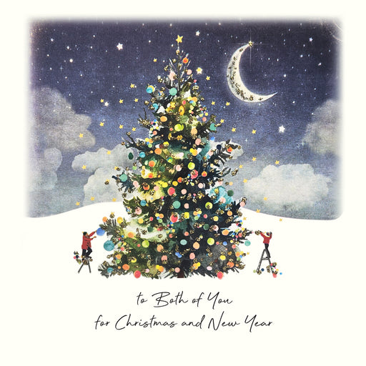 An illustrated Christmas card showing two figures decorating a large glittering Christmas tree under a starlit sky with a crescent moon, with hand painted glitter detail and the sentiment "to Both of You for Christmas and New Year"