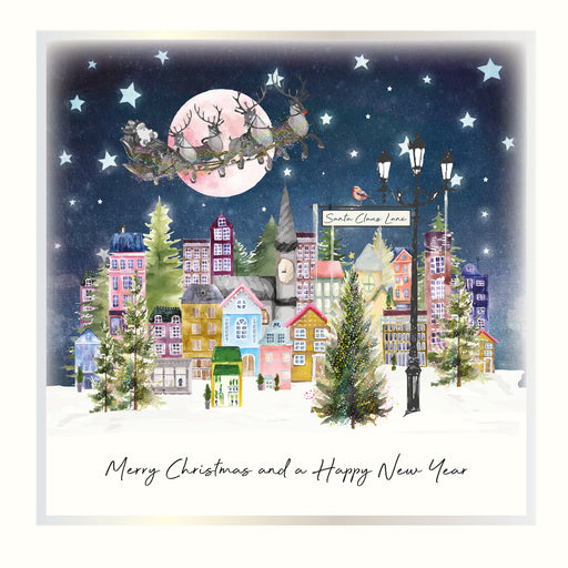 An illustrated Christmas card showing a colourful snow-dusted town at night with a Santa Claus Lane street lamp and perching robin, Santa's sleigh crossing a full moon in a starlit sky, with the sentiment "Merry Christmas and a Happy New Year"