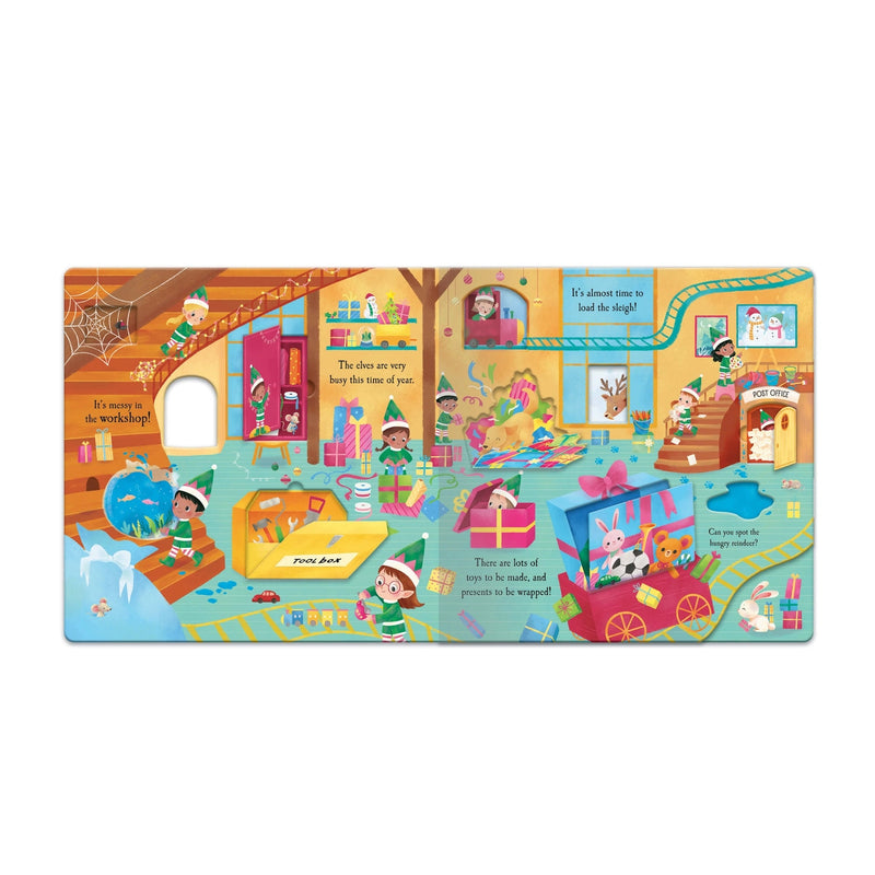 Let's Explore Santa's Village Book, open fold-out spread showing Santa's busy workshop with elves making toys, wrapping presents, a toy train, post office and peep-through hole, white background