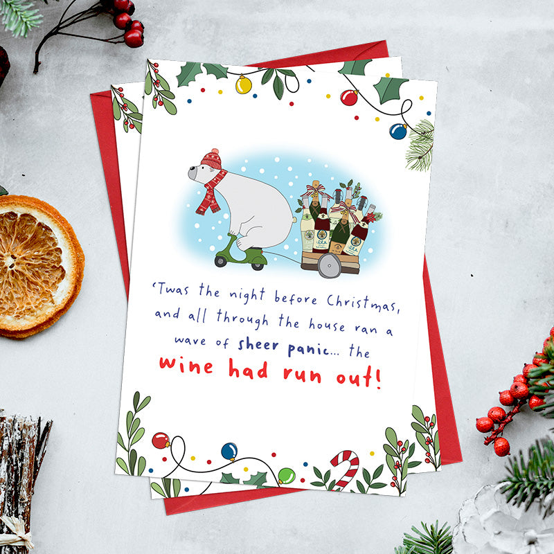 Pack of 6 The Wine Had Run Out Christmas cards featuring a polar bear in a scarf and bobble hat riding a scooter and towing a trailer of wine bottles