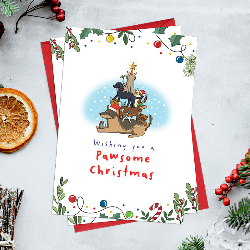 Pack of 6 Pawsome Christmas cards featuring illustrated cats and dogs arranged in a Christmas tree shape beneath a star, with festive foliage and bauble details.