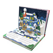 The Night Before Christmas Pop-Up Book open spread showing Santa in his sleigh pulled by reindeer flying over a snowy village in a 3D pop-up night scene