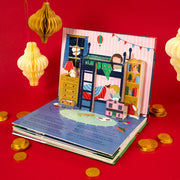 The Night Before Christmas Pop-Up Book open spread showing children sleeping in a bunk bed pop-up scene surrounded by gold coins 