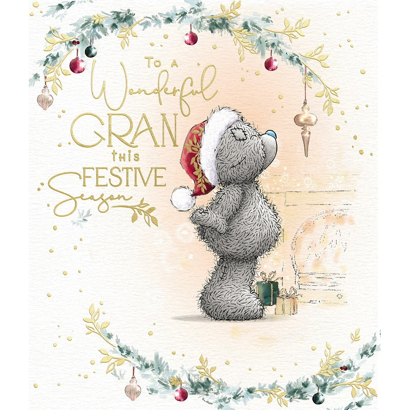 Wonderful Gran Tatty Teddy Christmas card featuring a bear wearing a Santa hat and gazing at a hanging bauble, with small presents nearby and festive foliage framing the design.