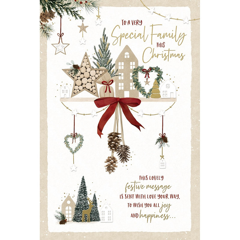 To a Very Special Family Christmas card featuring illustrated houses, a star, a heart-shaped wreath and festive trees on a shelf, with a ribbon bow and hanging pinecones