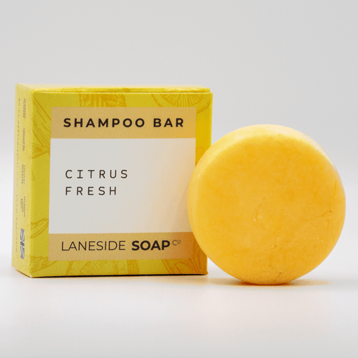 Laneside Soap Co Citrus Fresh Shampoo Bar 60g alongside its yellow box on a light grey background