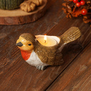 Country Living robin tea light holder, plump robin figurine with rich red breast and brown feathered body, lit tea light in back, autumn lifestyle shot on wooden surface