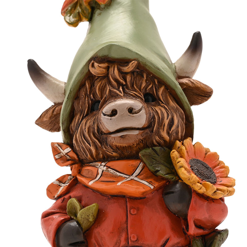 Close-up of Highland cow autumn figurine face, detailed shaggy fur, curved horns, sage green pointed hat and orange tartan scarf, white background