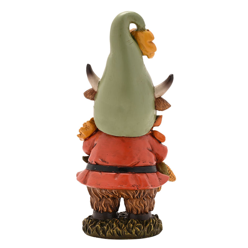 Highland cow autumn figurine, rear view showing sage green pointed hat and terracotta coat with black belt, shaggy fur detail, white background