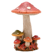  A resin mushroom cluster ornament with a tall central mushroom with a broad red cap and white spots, surrounded by smaller mushrooms, autumn flowers and leaves at the base, front view on a white background