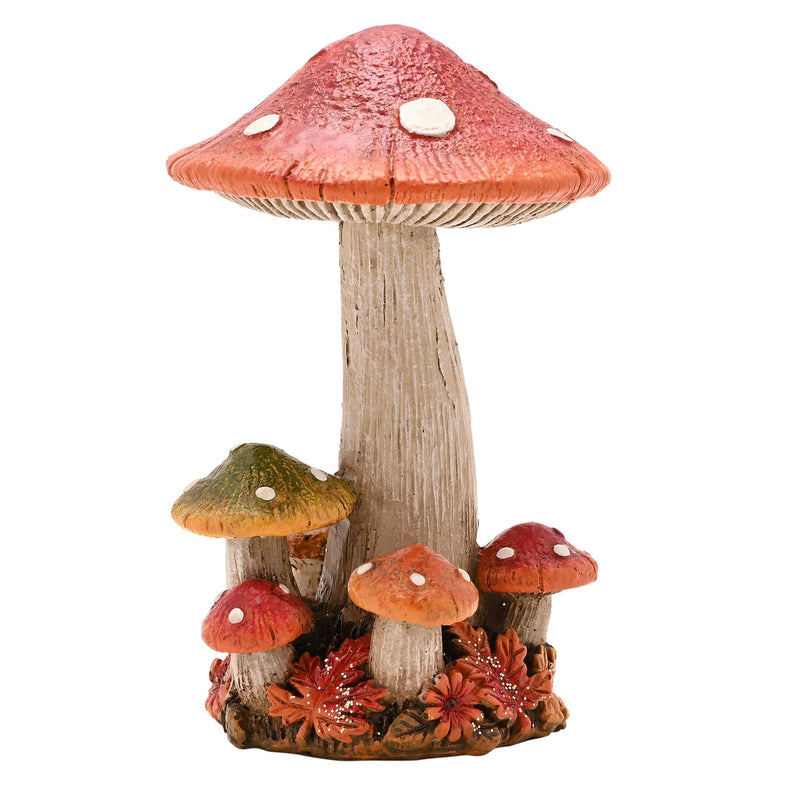  A resin mushroom cluster ornament with a tall central mushroom with a broad red cap and white spots, surrounded by smaller mushrooms, autumn flowers and leaves at the base, front view on a white background