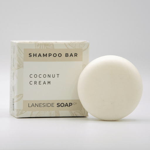 Laneside Soap Co Coconut Cream Shampoo Bar 60g alongside its cream box on a light grey background