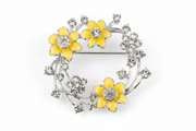 Equilibrium Radiant Daffodil Round Brooch with yellow daffodil flowers and crystal-effect stones on white background