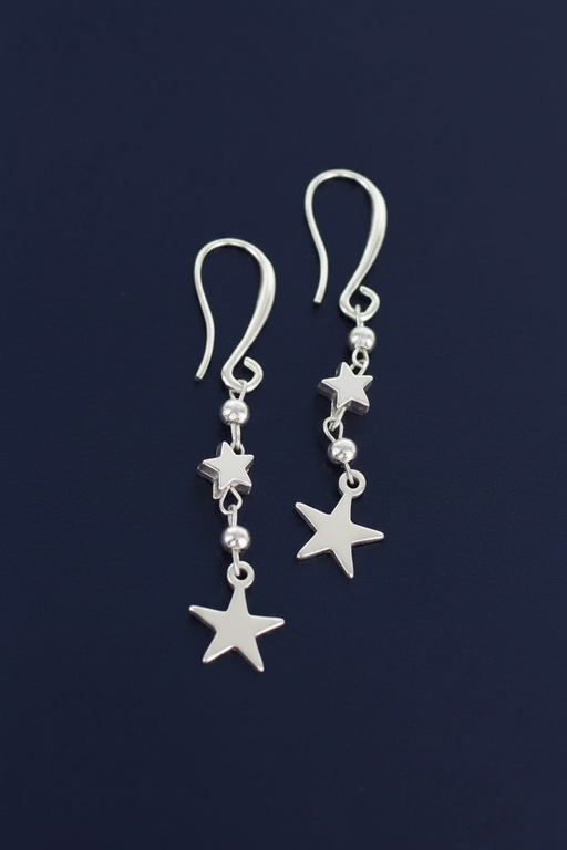 Silver plated drop earrings with two graduating star charms linked by silver plated beads on hook fittings, on a deep navy blue background