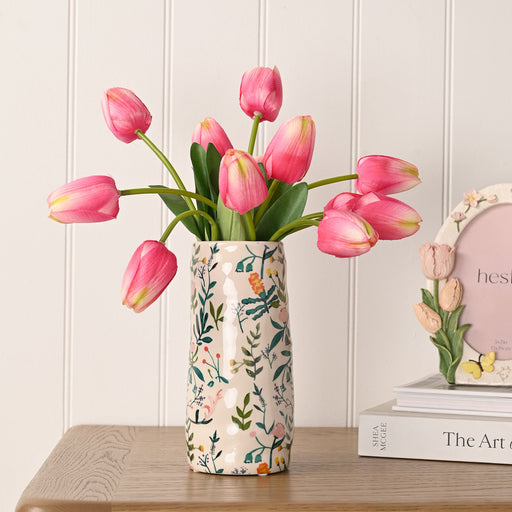 Hestia botanical garden vase filled with pink tulips styled on a wooden surface