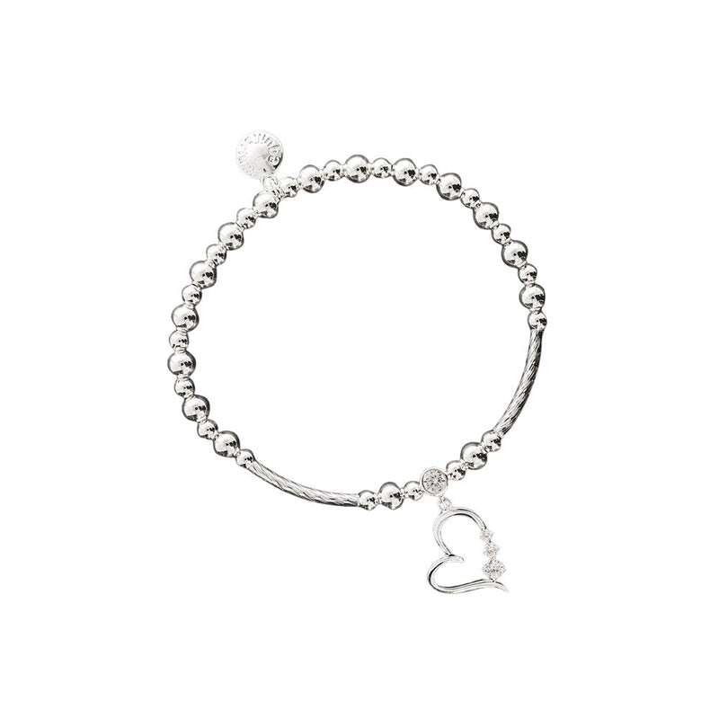Equilibrium Open Heart Crystal Silver Plated Stretch Bracelet with silver plated ball beads, bar sections, open heart charm with crystal-effect stone at the bail and three graduating crystal-effect stones along the side, and Equilibrium disc charm, on white background