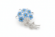 Equilibrium Forget Me Not silver-tone brooch with blue flower bouquet, amber crystal-effect centres and clear crystal-effect bow detail, on white background