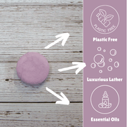Laneside Soap Co Lavender Shampoo Bar on a wooden surface with feature callouts: Plastic Free, Luxurious Lather, and Essential Oils