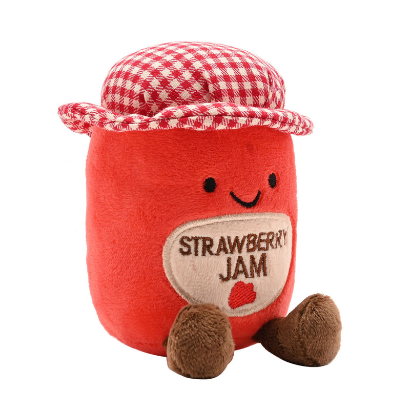 Angled view of a soft red plush strawberry jam jar toy with a stitched Strawberry Jam label, smiling face, red and white gingham hat and fluffy brown feet, on a white background