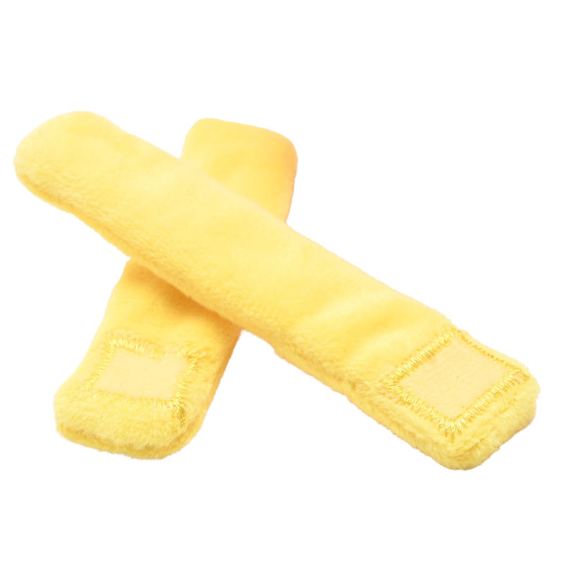 Two yellow plush French fry pieces crossed over each other, soft and chunky with stitched detail, on a white background