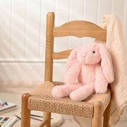 Katie the plush long leg light pink bunny soft toy 35cm, lifestyle shot — sitting on a chair