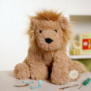 5 Leo the plush sitting brown lion soft toy 23cm, lifestyle shot — a cuddly companion for budding builders and lion lovers