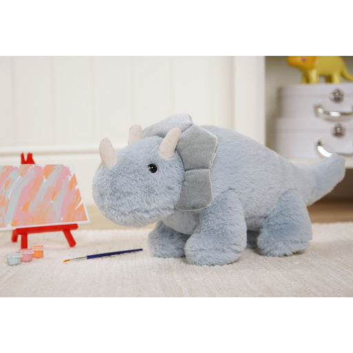 Tyrone the Triceratops plush dinosaur in a child's bedroom setting