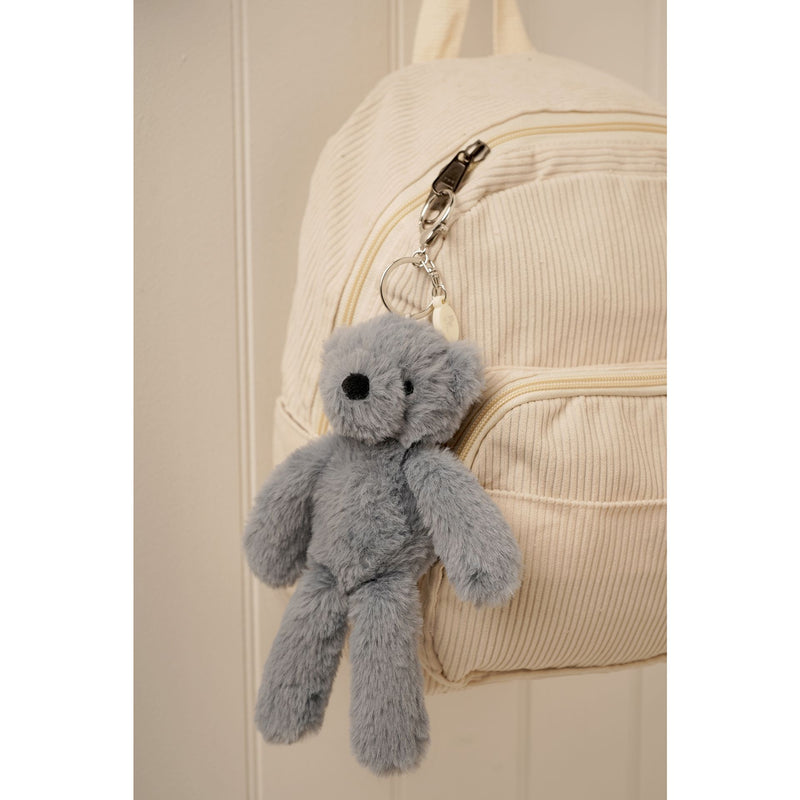 Pip the Plush Petrol Bear keyring and bag charm clipped to a bag