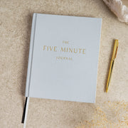 Serenity 5 Minute Journal front cover, hardcover with minimalist design, styled with pen