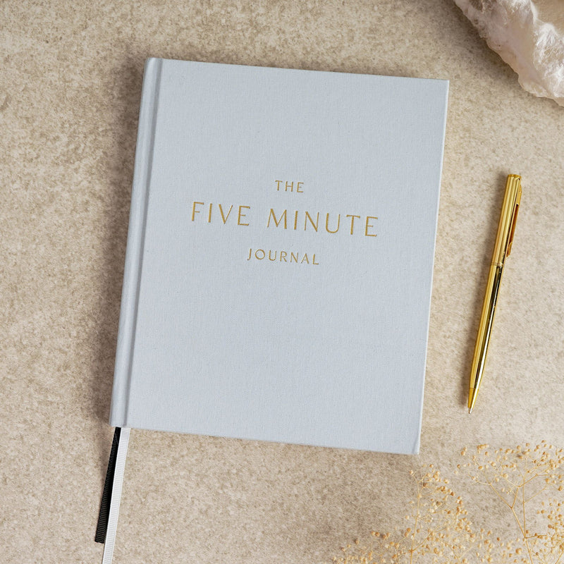 Serenity 5 Minute Journal front cover, hardcover with minimalist design, styled with pen