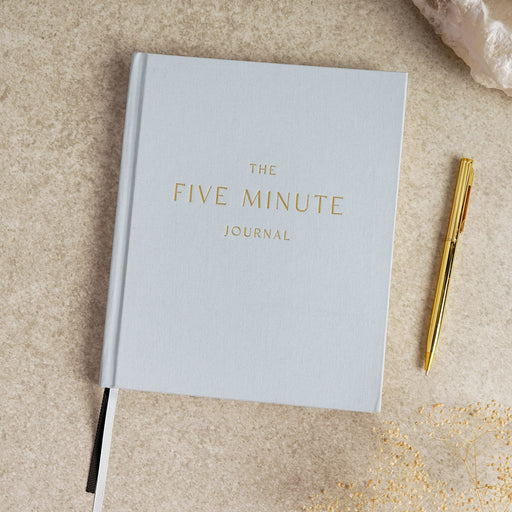 Serenity 5 Minute Journal front cover, hardcover with minimalist design, styled with pen