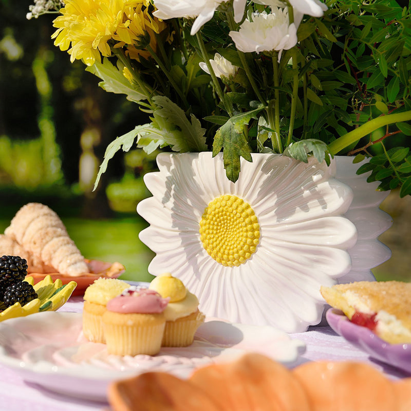 The Cottage Garden daisy ceramic vase by CELEBRATIONS, lifestyle shot — filled with flowers in an afternoon tea setting