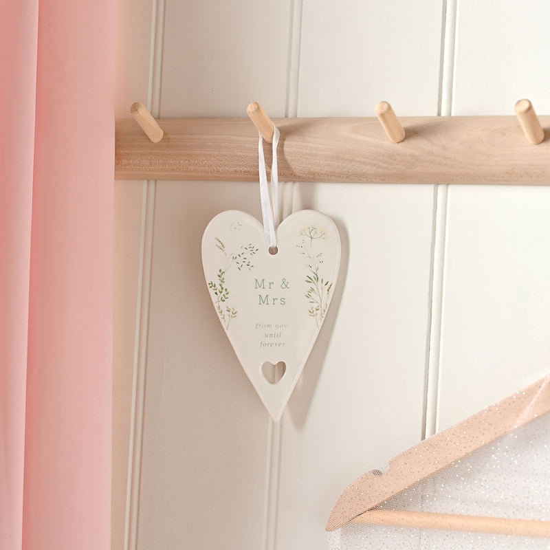  Love Story Mr & Mrs ceramic heart ornament 13cm, lifestyle shot — hanging on a wooden row of hooks