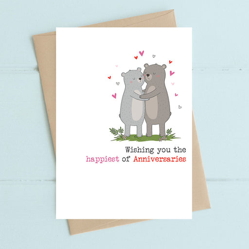 Anniversary card featuring two illustrated bears in a warm embrace surrounded by floating hearts with the sentiment Wishing you the happiest of Anniversaries